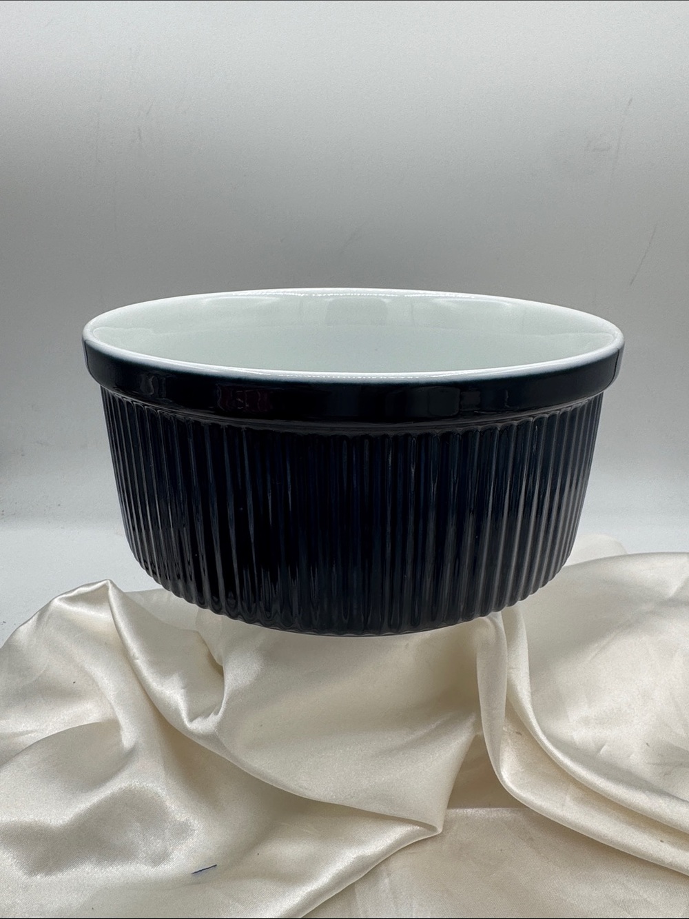 Dansk navy blue ribbed ceramic soufflé dish, a classic fluted exterior.